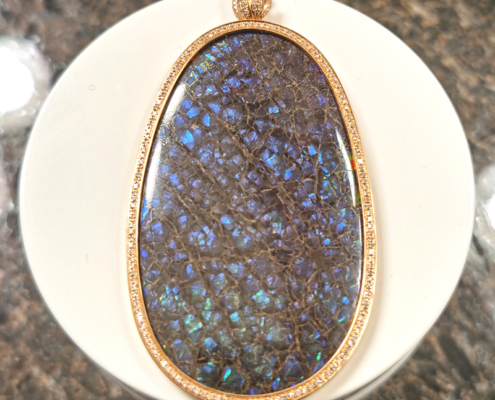 DIY Jewelry Custom 18K Gold Made Double-sided red color Ammolite set into an18K gold swiveling pendant setting accented with diamonds all around